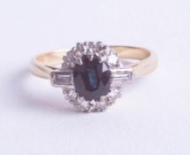 A small 18ct sapphire and diamond cluster set with a round cut and baguette cut diamonds, ring