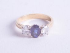 A fine 18ct diamond and sapphire three stone ring, size N.