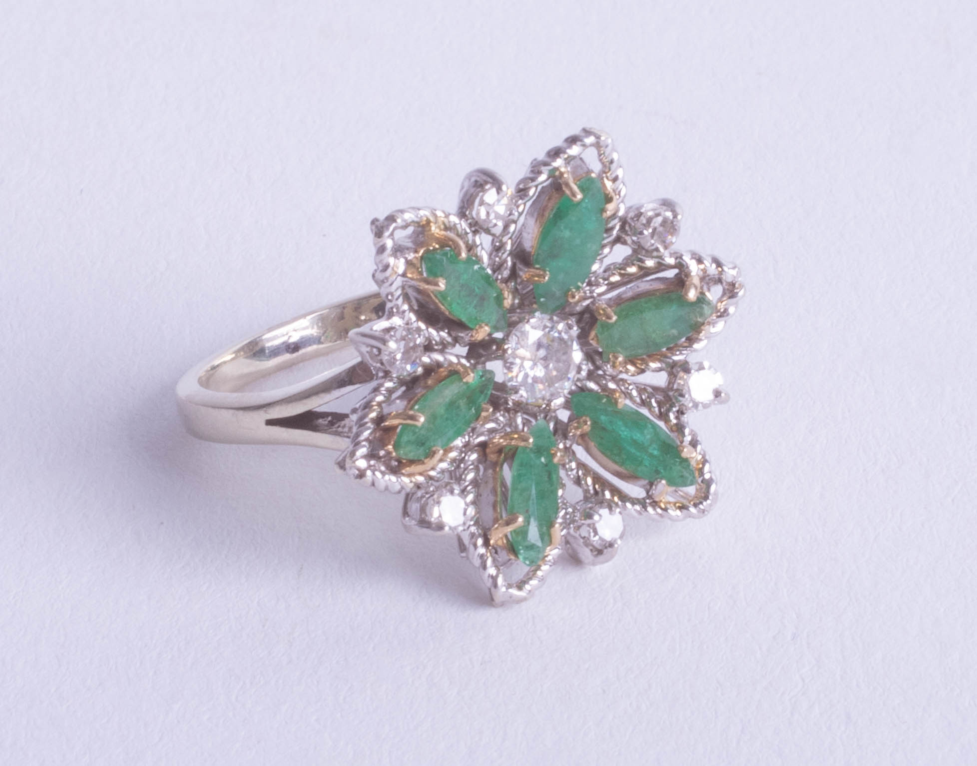 An 18ct emerald and diamond cluster ring, size M.