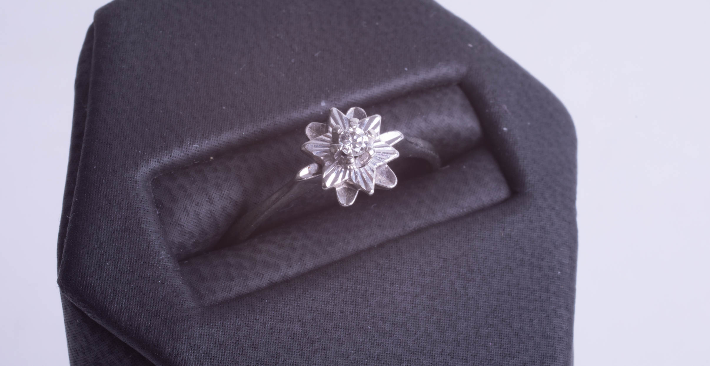 A small 18ct illusion set diamond flower ring, ring size N. - Image 2 of 2
