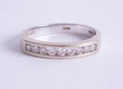 A 18ct nine stone diamond half band eternity ring, approx 0.33ct, size M.