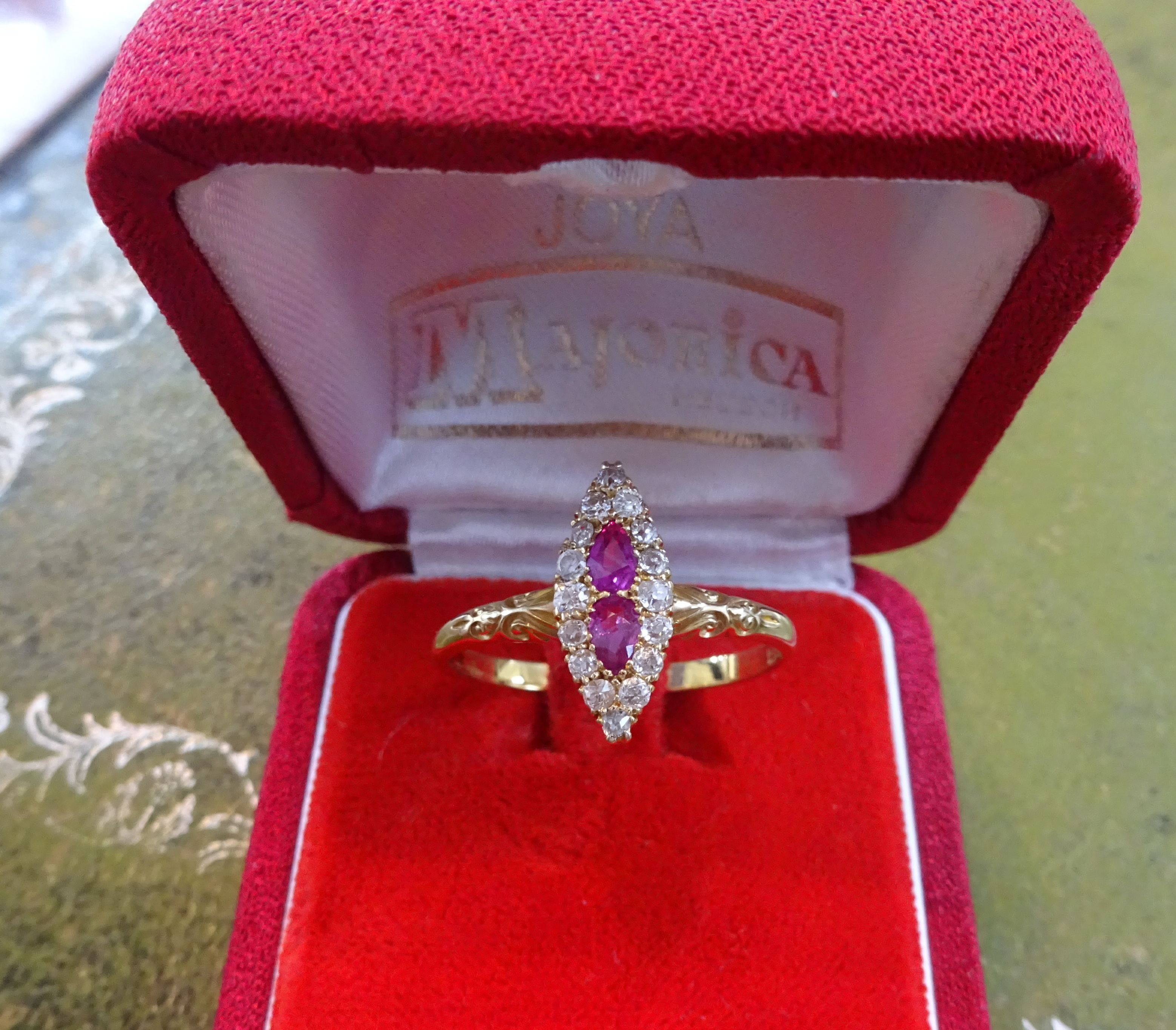 An 18ct ruby and diamond marquise set ring, size W.