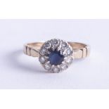 A sapphire and diamond cluster ring set in 9ct gold, size V.