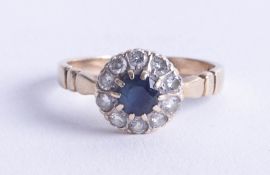 A sapphire and diamond cluster ring set in 9ct gold, size V.