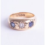 An 18ct three stone sapphire and diamond ring, size M.