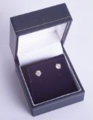 A pair of 18ct diamond stud earrings, weight approx. 0.75ct.