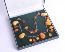 A modern mixed amber necklace, boxed.