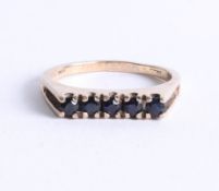 A 9ct gold channel set ring, size Q.