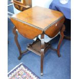 A mahogany drop flap games table with pull-out counter drawers with a lower tier and shaped legs.