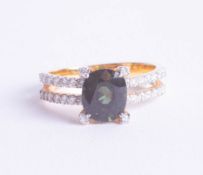 A green sapphire and diamond set ring in yellow gold.