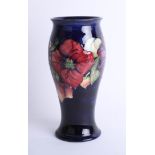 A Moorcroft blue anemone vase, height 25cm stamped and signed.