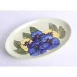 A Moorcroft pale green pansy tray, width 23cm with stamp and label.