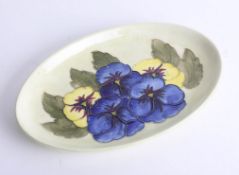 A Moorcroft pale green pansy tray, width 23cm with stamp and label.