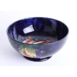 A Moorcroft blue leaf and berry bowl, diameter 16cm, stamped and signed.