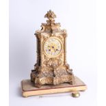 A heavy French gilt mantle clock with bell strike and pendulum with enamel cartouche dial, ornate