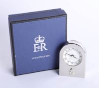 A small clock, silver effect presented by Queen Elizabeth II to the royal household Christmas