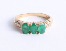 An 18k yellow gold emerald and diamond ring, size O.