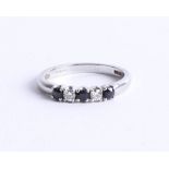 A platinum sapphire and diamond set five stone ring, size N.