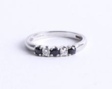 A platinum sapphire and diamond set five stone ring, size N.