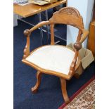 A light oak captains office swivel armchair.