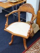 A light oak captains office swivel armchair.