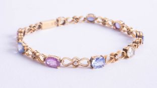 Mixed colour sapphire and gold set bracelet set in yellow gold possibly 18ct.