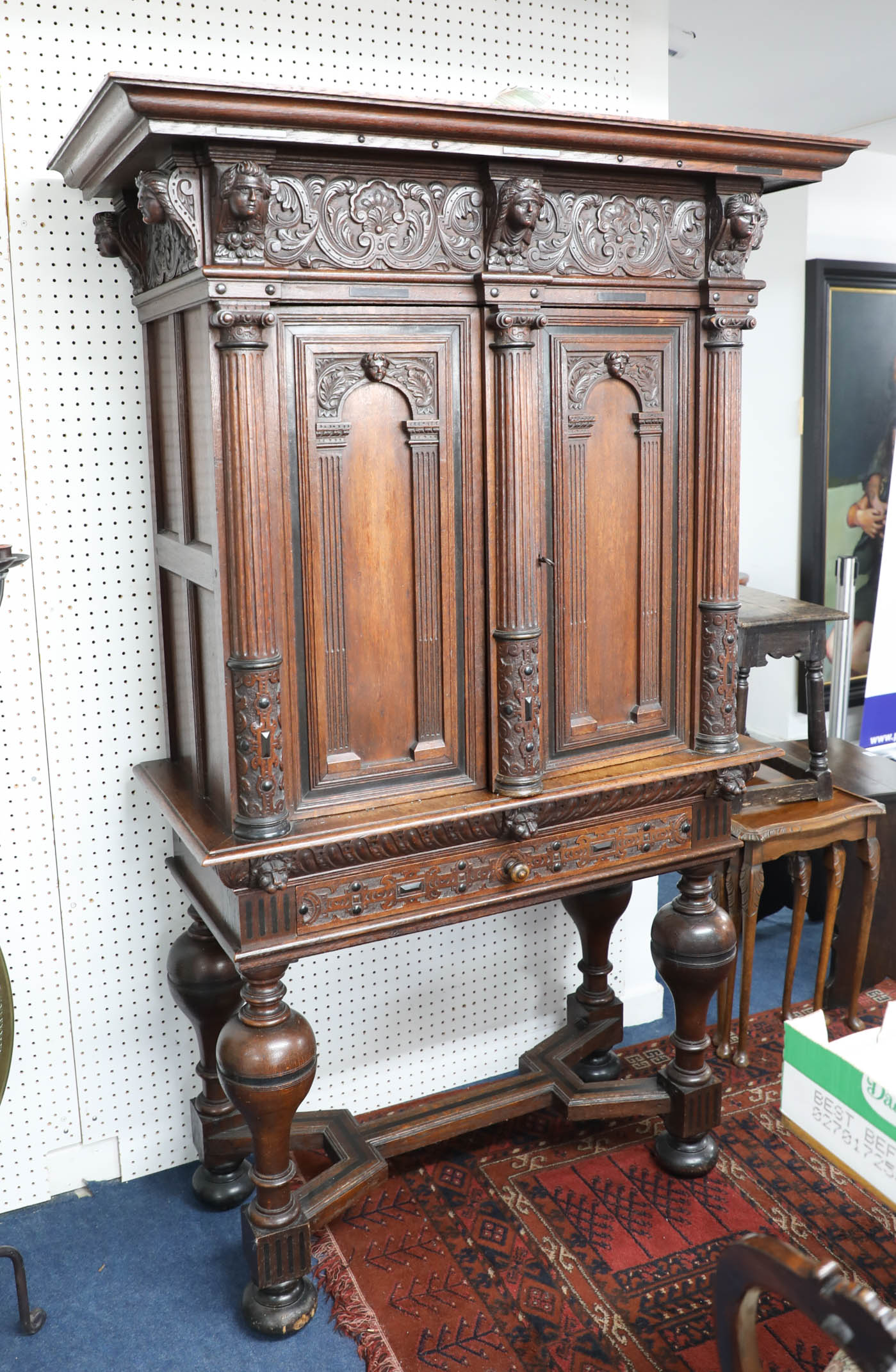 A continental Dutch? carved oak cabinet, on stand, the base with bulbous legs and shaped