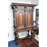 A continental Dutch? carved oak cabinet, on stand, the base with bulbous legs and shaped