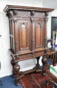 A continental Dutch? carved oak cabinet, on stand, the base with bulbous legs and shaped