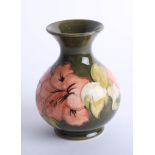 A Moorcroft green hibiscus vase, height 14cm with label.