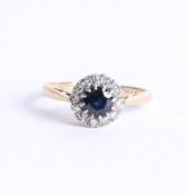 An 18ct sapphire and diamond cluster ring set in yellow gold.