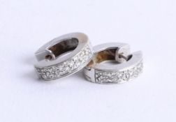 A pair of 18ct white gold and diamond set creole earrings.