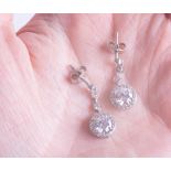A pair of silver dress earrings with paste diamonds.