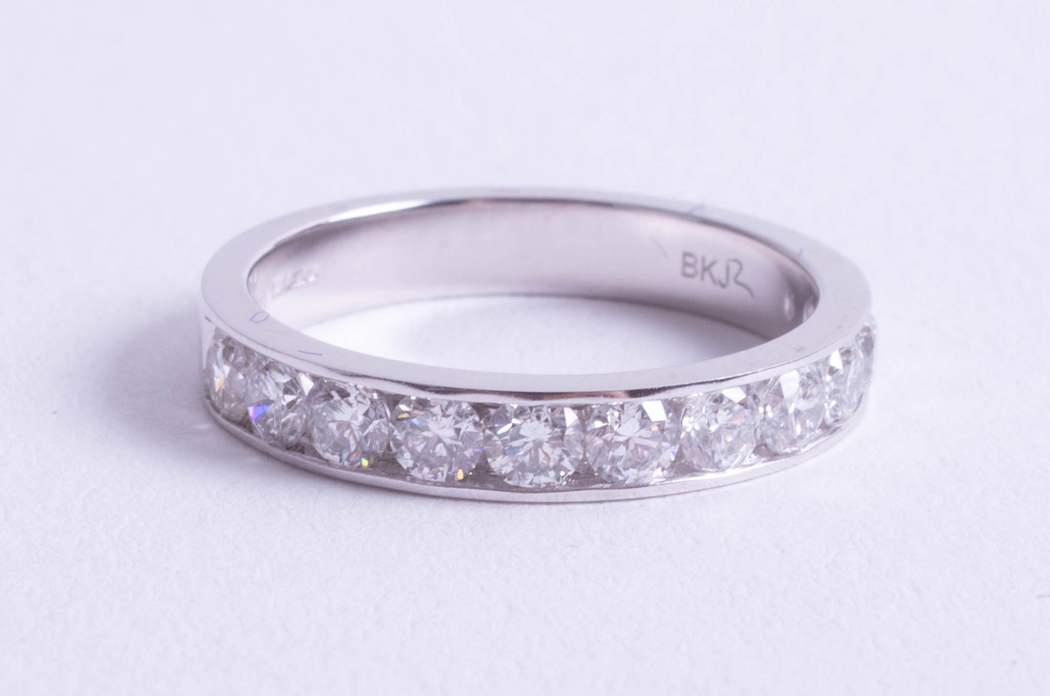 An 18ct white gold and diamond set half band eternity ring, size M.