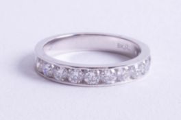 An 18ct white gold and diamond set half band eternity ring, size M.