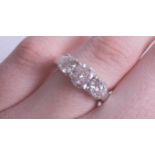 A fine three stone diamond ring, platinum mount, total diamond weight approx 2.75 cts, judged to