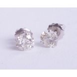 A pair of 14ct diamond set earrings, set in white gold, two round, brilliant cut diamonds, weight