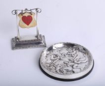 A silver card game stand, height 10cm, together with a Swedish silver coaster, marked GAB (