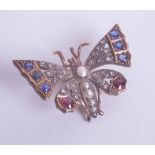 A Victorian ruby and diamond set butterfly brooch.