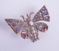 A Victorian ruby and diamond set butterfly brooch.