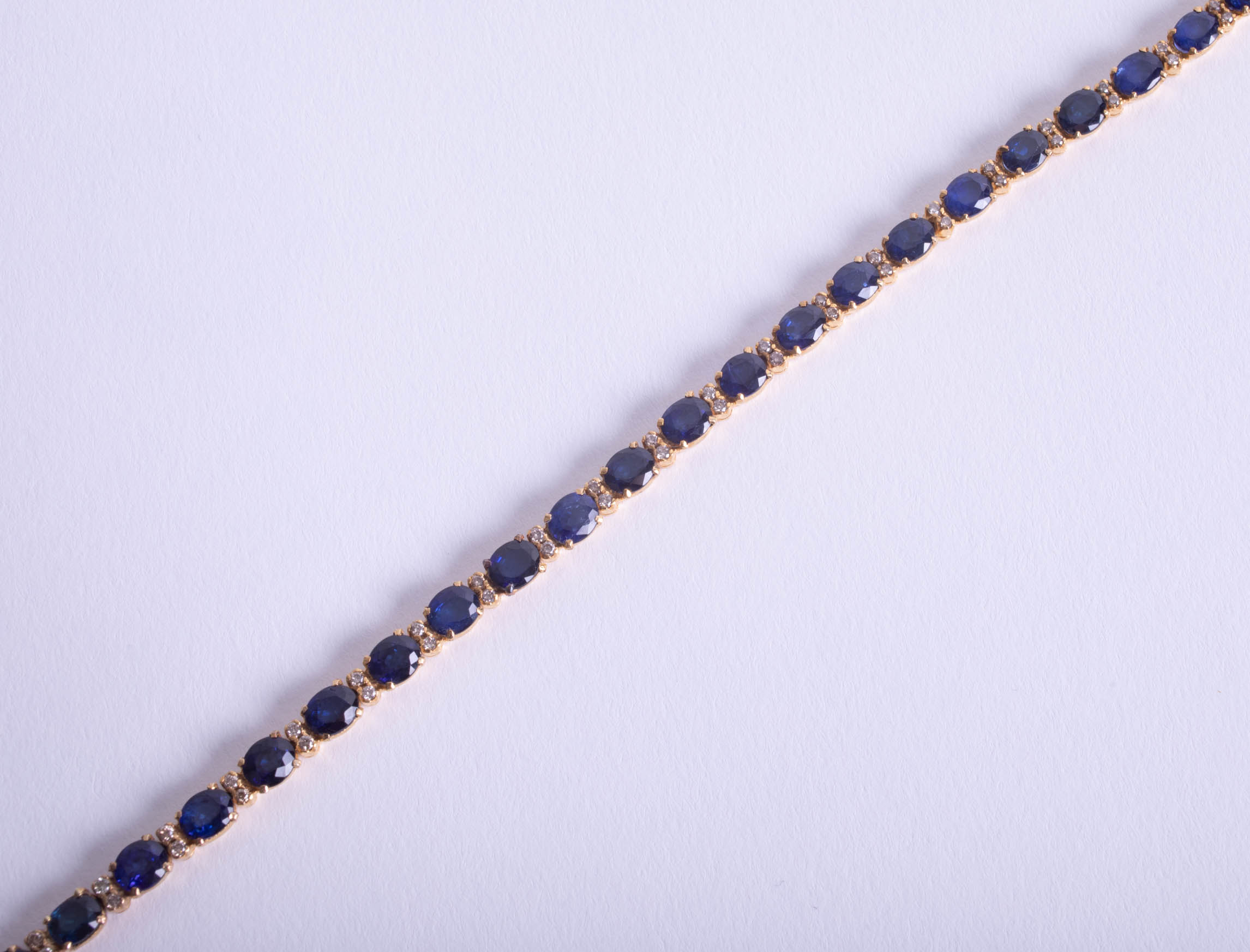 A sapphire and diamond line bracelet, set in yellow metal possibly 18ct, not hallmarked, length - Image 2 of 2