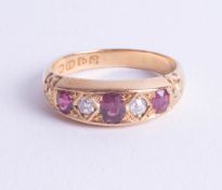 An antique 18ct ruby and diamond set ring, size O.