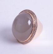 An impressive, huge moonstone and diamond set ring, signed Adler, size range O to Q.