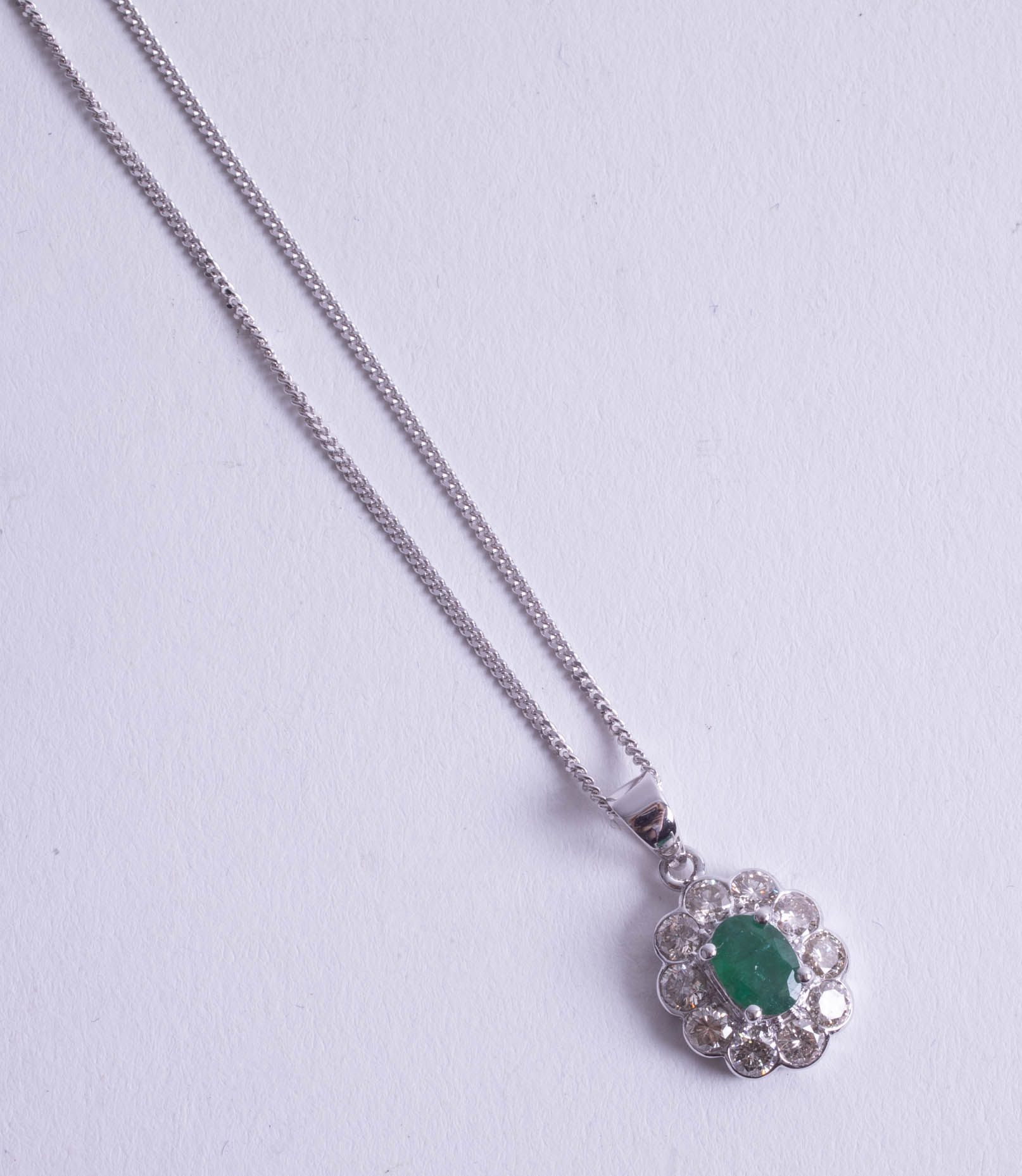 A fine emerald and diamond set pendant.