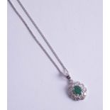 A fine emerald and diamond set pendant.