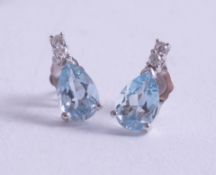 A pair of 18ct white gold aquamarine and diamond earrings.