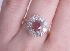 An 18ct ruby and diamond cluster ring, size M.