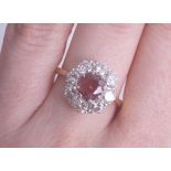 An 18ct ruby and diamond cluster ring, size M.