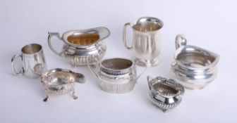 A small silver tankard, together with various silver cream jugs, sucre, and crystal mug (7) 29.