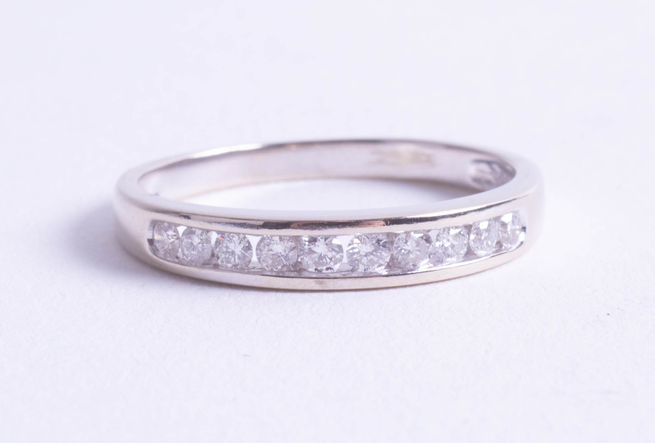 An 18ct white gold and diamond set half band eternity ring, size R.